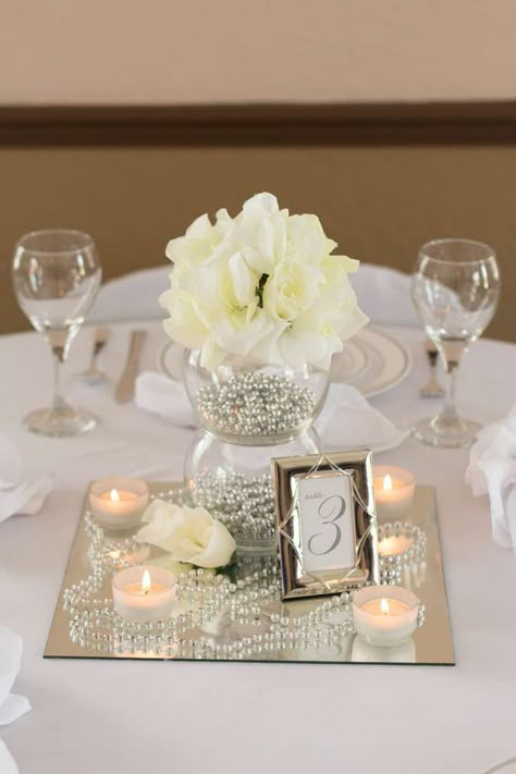 White, Ivory, Silver Wedding Party Ideas | Photo 1 of 6 White And Silver Wedding Centerpieces, Mirror Centerpiece Ideas Party, White And Gold Centerpiece, Square Mirror Centerpiece Wedding, Pearl Centerpiece Ideas Diy, Mirror Tile Centerpiece, Silver Party Centerpieces, Wedding Centerpieces On Mirrors, Mirror Centerpiece Ideas Wedding