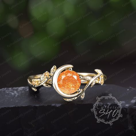 Unique sunstone moon engagement ring Art deco solid 14K gold promise ring Nature inspired orange gemstone leaf ring Jewelry gift for women Engagement ring Center Stone: Sunstone Cut: Round cut Size:6mm Side stone: Citrine Weight: 0.024ctw Width: 2mm Thickness: 1.2mm Metal: 925 sterling silver or 10K/14K/18K Yellow/ White/Rose Gold or platinum  Or Black gold: The underneath metal is in Silver/ 10K/14K/18K white gold, coated with black rhodium Processing time Dute to all our jewelry are made to order for each customer.Your package will ship within 3-4 weeks of purchase.We need to ensure the quality of each jewelry.Thank you for your patience.  More Information *Custom Order *Rush Orders *Payment plan *Engraving service *Free gift box If you have any questions else, Please feel free to contac Orange Engagement Ring, Sailor Moon Ring, Autumn Ball, Moon Engagement Ring, Sunstone Engagement Ring, Orange Ring, Gold Promise Ring, Leaf Engagement Ring, Gold Promise Rings