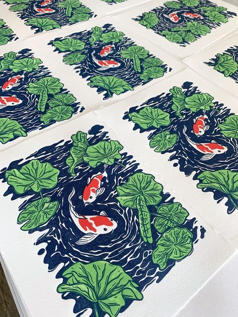 Overlapping blue, green, and red artwork featuring two koi fish swimming amongst water lilies. Koi Block Print, Multi Block Printmaking, Koi Fish Block Print, Multi Layer Linocut, Multi Block Lino Print, Koi Pond Illustration, Multicolor Linocut Prints, Koi Fish Linocut, Layered Lino Print