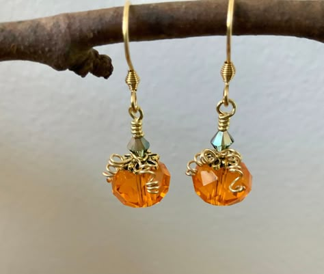 Orange crystal beads with golden accents and wire wrapped tendrils and a Swarovski crystal stem dangle from hypoallergenic gold plated ear wires. These sparkly pumpkins will look stunning for your Halloween parties and for the entire fall season! Your earrings will arrive in a jewelry box perfect for gifting or keeping. As always, shipping is free and fast. Thanks for stopping by my shop Thanksgiving Earrings Diy, Fall Earrings Diy, Halloween Jewelry Diy, Pumpkin Jewelry, Wire Jewerly, Beaded Projects, Autumn Earrings, Leaves Necklace, Autumn Jewelry