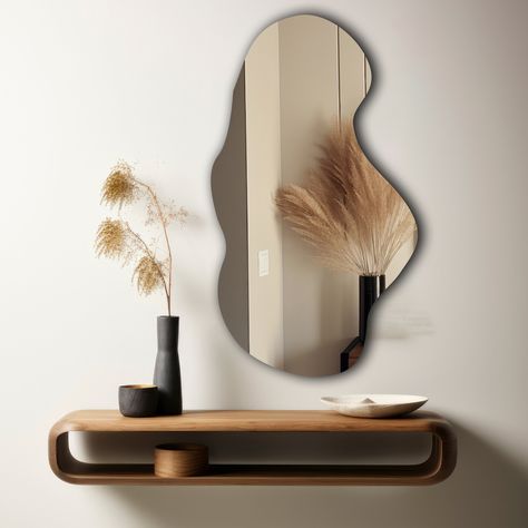 Introducing our stunning asymmetric mirror, a unique statement piece that will elevate any space. Handcrafted with precision and attention to detail, this mirror features an innovative asymmetrical design that adds a touch of modern elegance. The perfect focal point for your entryway, living room, or bedroom, this mirror reflects light beautifully and creates the illusion of a larger space. The high-quality materials and sleek frame ensure durability and longevity. Whether you're looking to add Aesthetic Room Wall Decor, Organic Mirror, Pond Mirror, Mirror Bedroom Decor, Wall Decor Mirror, Curved Mirror, Unique Mirror, Future Bedroom, Vanity Art