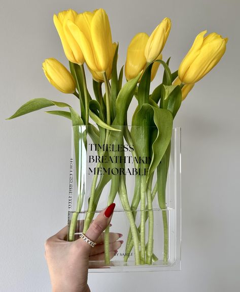 PRICES MAY VARY. High- Quality Material: This clear book vase for flowers is crafted with 3MM thickness premium quality acrylic material that looks like glass, is durable, less prone to damage, and is lightweight Product dimentions: 5.9"x1.6"x7.9" (LxWxH) It has the perfect size whether you want to display a beautiful bouquet or use it as a stylish desktop accessory, this vase is a versatile addition to your decor. Perfect Decoration: Transform your living space into a chic and stylish haven wit Plants In Clear Vase, Flowers In Vases Decor, Book Flower Vase, Book Vase, Future Furniture, Clear Book, Book Centerpieces, Modern Florals, Vase Transparent