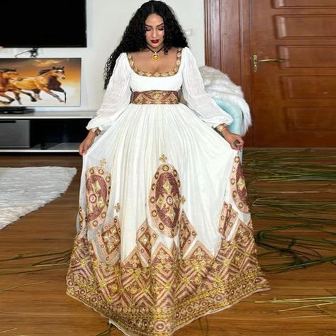 Modern Habesha dresses beautifully combine cultural heritage with contemporary styles, offering elegance for every occasion. They reflect the vibrant culture of Ethiopia and Eritrea while appealing to global fashion trends. Eritrean Clothing, Ethiopian Wedding Dress, Ethiopian Fashion, Ethiopian Wedding, Ethiopian Clothing, Ethiopian Traditional Dress, Ethiopian Dress, Habesha Kemis, Authentic Fashion