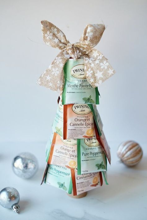 If you're looking for a cheap but thoughtful Christmas gift, you can't go wrong with this tea bag Christmas tree!﻿When you just don't have enough money to give gifts, but you want to anyway, this Christmas tea tree is an excellent thrifty gift idea. Supplies 1 Styrofoam cone (7 inches)2 packages of tea bags (approx. 10-12 of each)Bow (optional)Toilet paper tube (optional) Sort Your Tea Remove tea bags from the boxes. Sort by colors if you have different types. Attach Bags Laye… Free Printable Christmas Cards, Alternative Christmas, Alternative Christmas Tree, Enough Money, Christmas Gifts For Coworkers, Thoughtful Christmas Gifts, Free Christmas Printables, Rustic Christmas Tree, Printable Christmas Cards