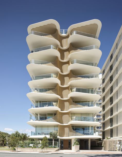 Drawing inspiration from local Norfolk pines, the latest mixed-use residential project by Koichi Takada Architects is a sculptural and sympathetic addition to its coastal location in Burleigh Heads (Queensland, Australia). The organic, overlapping architectural curves and linear screening form the basis for this responsive building with passive design principles at play. Koichi Takada, Housing Architecture, Building Skin, Norfolk Pine, Passive Solar Design, Timber Roof, Burleigh Heads, Passive Design, Retractable Screen