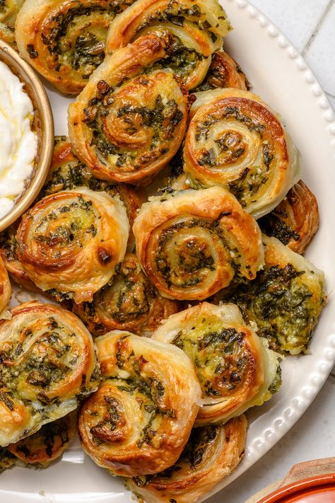 These Spinach and Feta Pinwheels are a quick spin on Greek Spanakopita. Spinach Feta Stuffed Croissants, Spinach + Feta Cookies (spanakopita Cookies), Cranberry Spinach Pinwheels, Spinach And Feta Pastry Rolls, Spinach Feta Rolls, Spinach And Feta Pastries, Host Lunch Ideas, Spinach Pinwheels Crescent Roll, Puff Pastry Starters