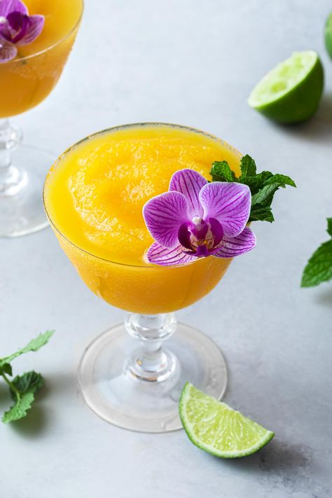 Enjoy a tropical drink with this easy passion fruit daiquiri made with frozen passionfruit pulp that brings out the bright and vibrant, natural flavor of the fruit. Blended to perfection with triple sec and white rum, this passionfruit cocktail is smooth, sweet and tart. Passionfruit Daiquiri, Passion Fruit Daiquiri, Fruit Cocktail Drink, Midsommar Party, Passionfruit Cocktail, Frosé Recipe, Recipes With Fruit Cocktail, Banana Cocktails, New Years Cocktails