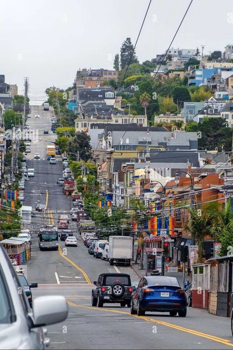 Castro Street, San Francisco, California. Hill with cars, houses, shops and rainbow flags. Castro Street San Francisco, Rainbow Flags, California Hills, San Fran, Rainbow Flag, Street Scenes, Street Photography, Shop House, San Francisco