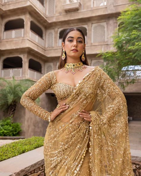 Liquid gold vibes 🌟 ...... MARISTELA - Metallic gold hand embroidered saree with a full sleeve blouse along tassel droplets at waist and gorgeous sequins edging. Cosmos: A Cocktail Affair Discover the collection: Online at Roujeofficial.com via link in bio Calcutta | Hyderabad Jewelry:@gkchudiwalas [ Roujeofficial, rouje, Cosmos, feathered cape, tassels, crystals, sequins, hand embroidery, cocktail saree, party outfits, after party outfit, bridesmaid outfit, Sangeet, wedding day, re... Golden Sangeet Outfit, Gold Blouses For Sarees, Cocktail Party Outfit Bride, Golden Saree Bridal Look, Full Sleeve Blouse Designs Saree Indian Weddings, Full Sleeve Saree Blouse Design, Lengha Blouse Designs Full Sleeves, Full Sleeves Blouse Designs Saree, Reception Outfit Bridesmaid