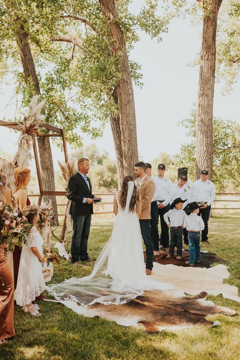 Cowhide rug wedding ceremony. Western boho wedding Cowhide Wedding Ceremony, Cow Hide Rugs Wedding, Wedding Cowhide Rug, Cow Hide Rug Wedding, Western Wedding Ring Bearer, Cowhide Rug Wedding, Rug Wedding Ceremony, Wedding Cowhide, Cowhide Wedding