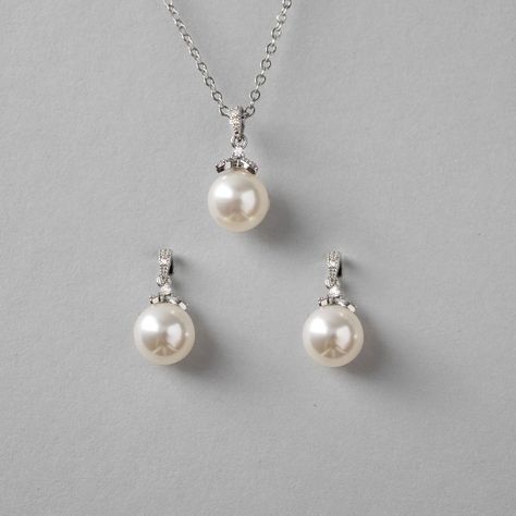 Simple yet alluring pearl earrings and necklace set. A single pearl hangs from a micro CZ accented drop for a little sparkle to your style. They are both about .75 inches long with a 10mm pearl and the necklace is 16 inches with a 2-inch extender. Available in rhodium or gold plate, they are lead, nickel, and cadmium-free. #bridesmaidgifts #weddinginspiration #weddingnecklaceset #bridalnecklace #bridalnecklaces #bridalnecklaceset #pearlpendant #pearlpendants Wedding Pearl Jewelry Set, Single Pearl Necklace Silver, Pearl Earrings And Necklace, Pearl Jewelry Set, Wedding Necklace Set, Single Pearl Necklace, Earrings And Necklace Set, Vibe Check, Single Pearl