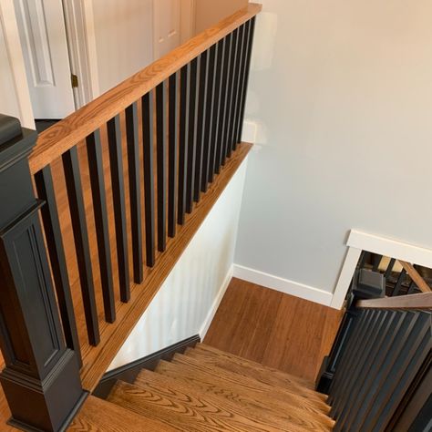 Oak stairs stained with Minmax English Chestnut with off-black wooden balusters and post. Black Balusters Wood Handrail, Modern Oak Stair Railing, Wooden Banister Ideas, Black Wooden Banister, Refinish Oak Stair Railing, Oak Banister With Black Spindles, Wood And Black Railing, Black And Wood Banister, Oak Handrail Black Spindles