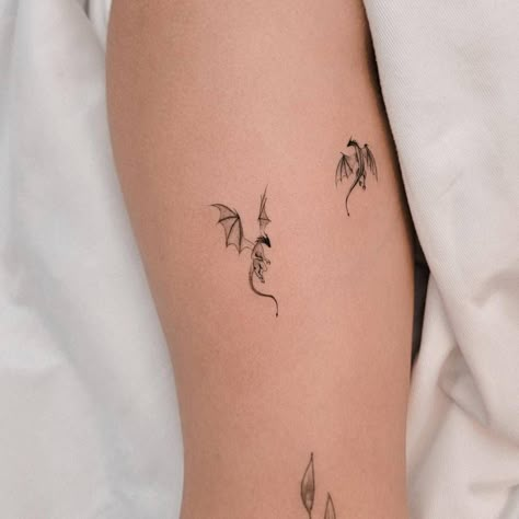 Small Dragon Shoulder Tattoo, Here Be Dragons Tattoo, Dragon With Lightning Tattoo, Dragon Ring Tattoo, Sitting Dragon Tattoo, Baby Dragon Tattoo For Women, Feminine Dragon Tattoo For Women Arm, Book And Dragon Tattoo, Simple Dragon Tattoo For Women