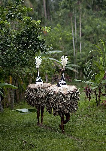 Tumbuan (or tubuan) dance in Karavia liu village. ~The masks are supposed to be female. ~There are male masks, but they are higher. ~The Tumbuan means also the secret culture of the Tolai. ~Some men…are under the giant mask. ~Women are not supposed to watch the dance. ~The dance is also called Dukduk dance. ~The Dukduk society uses male duk duk and female tubuan masks. ~Both types are cone-shaped and are constructed of cane and fiber... | East Britain, Papua New Guinea | Eric Lafforgue Charles Freger, Mouth Painting, Eric Lafforgue, Female Mask, Art Premier, We Are The World, New Guinea, African Masks, World Cultures