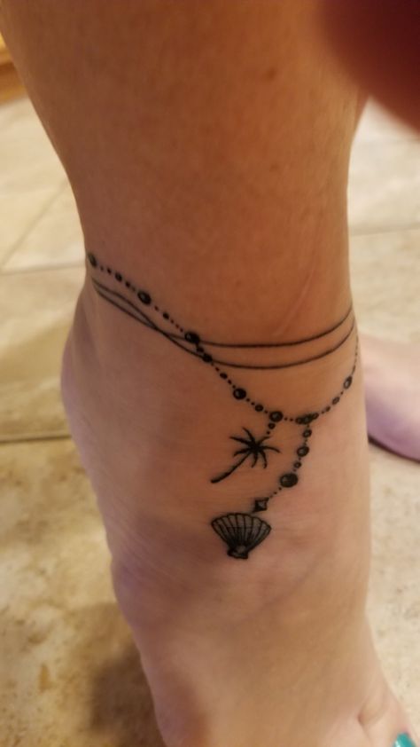 Cute Anklet Tattoos, Beach Anklet Tattoo, Families Tattoos, Anklet Tattoos For Women Unique, Anklet Tattoos Wrap Around, Ankle Chain Tattoo, Ankle Bracelets Tattoos For Women, Tattoo Ideas Foot, Charm Anklet Tattoo