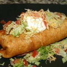 CHIMI-CHANGA One flour tortilla, soft or deep fried, filled with beef tips, beans and topped with cheese, lettuce, tomato, guacamole and sour cream. $8.95 Chimichanga Recipe, Chili Relleno, Beef Dishes, Deep Dish, Mexican Dishes, Buffalo Chicken, Comfort Foods, Main Dish Recipes, Deep Fried