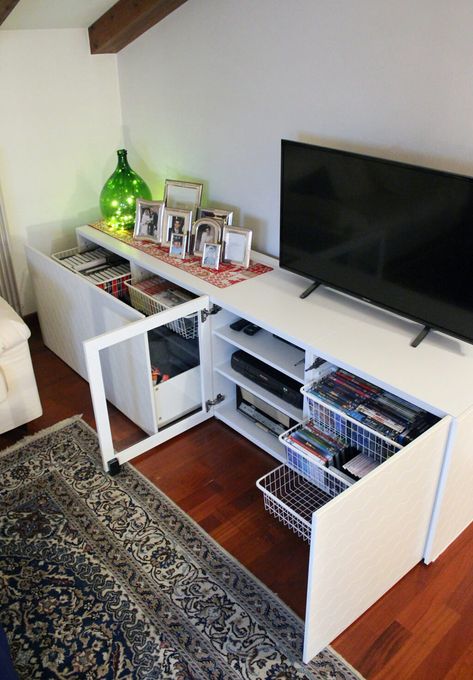 I like this for my top DVD storage - won't hold them all. I could still add the gold accents.   White TV stand IKEA hack with lots of storage Tv Stand Ikea, Stolmen Ikea, Tv Stand Ikea Hack, White Living Room Furniture, Ikea Tv Stand, White Tv Stand, Ikea Tv, Swivel Tv Stand, White Tv Stands