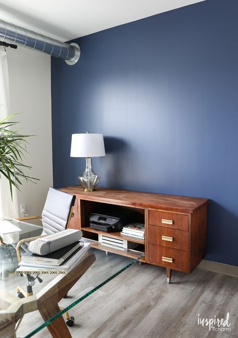 the navy blue accent wall is Sherwin Williams, Indigo Batik - Feature Wall Paint for the Home Office - Inspired by Charm Sherwin Williams Indigo, Blue Feature Wall Bedroom, Blue Accent Wall Living Room, Feature Wall Paint, Navy Blue Accent Wall, Home Office Blue, Blue Accent Wall, Blue Feature Wall, Office Feature Wall