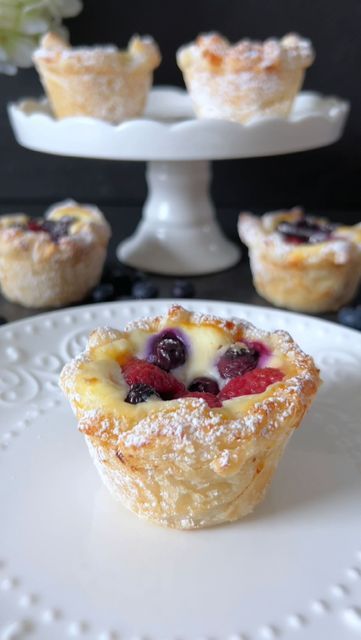 Food with Style 🤍 on Instagram: "Click here for the Recipe 🤍 Berry Pastry Indulge in the delightful fusion of crispy puff pastry, creamy cheesecake filling, and vibrant fruits with Berry Pastries! Perfect for a charming dessert experience 🥰 📝 Ingredients: - 1 sheet of puff pastry - 200 g quark or unsalted cream cheese - 1 egg yolk - 50 g powdered sugar - 1 teaspoon vanilla extract - 1 teaspoon cornstarch - Mixed berries (e.g., raspberries, blueberries) 🤍 Preparation: 1. Preheat the oven to 200 degrees Celsius. Grease and flour 6 muffin cups. 2. Cut the puff pastry sheet into 6 squares. Gently press each square into a muffin cup, creating a rustic appearance. 3. In a bowl, mix quark, egg yolk, powdered sugar, vanilla extract, and cornstarch until it forms a creamy consistency. 4. Puff Pastry And Berries, Irresistible Cream And Berry-filled Pastry Balls, Cream And Berry Pastry Balls, Cream And Berry Filled Pastry Balls, Berry Pastries, Berry Pastry, Puff Pastry Dessert, Puff Pastry Snacks, Phyllo Recipes