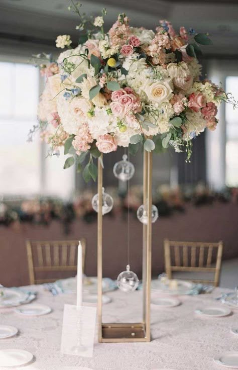 You’ve probably decided what your wedding theme is. Wedding reception centerpieces should be beautiful, but they don’t have to be difficult. There’s no need... Cheap Wedding Table Centerpieces, Wedding Table Pink, Tall Wedding Centerpieces, Tafel Decor, Wedding Floral Centerpieces, Tall Centerpieces, Wedding Event Design, Flower Centerpieces Wedding, Wedding Table Decorations