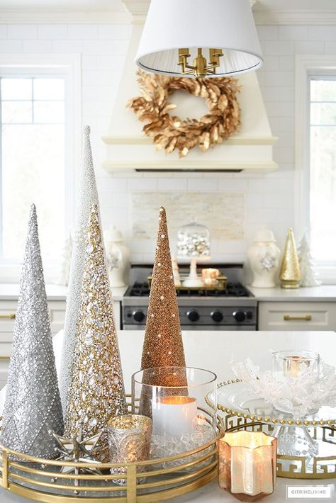 Elegant Christmas kitchen decorating with gold, silver and white. Glittery tress on a brass tray is the perfect touch on the kitchen island! #christmasdecor #christmasdecorating #christmaskitchen #christmasideas #christmastrees #holidaydecorating Silver Gold Christmas, Glam Christmas Decor, Christmas Cones, Silver Christmas Decorations, Elegant Christmas Decor, Rose Gold Christmas, Glam Christmas, Cone Christmas Trees, Gold Christmas Decorations