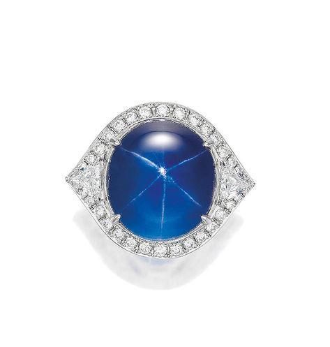 Hong Kong Jewels and Jadeite 25 Nov 2023 Lot #: 671 Title: STAR SAPPHIRE AND DIAMOND RING Estimate: HK$380,000 - 750,000 Description: The Property of an Asian Collector (Lots 630 - 672) STAR SAPPHIRE AND DIAMOND RING The cabochon star sapphire weighing 50.20 carats, within a stylised trilliant- and round brilliant-cut diamond frame, extended to the gallery, the diamonds together weighing approximately 3.80 carats;<i> mounted in platinum; ring size 6½</i> <b>Footnotes</b> Accompanied by a Lotus report numbered 3877-9938, dated 15 August 2023, stating that the 50.20-carat star sapphire is natural, Blue colour ("Cornflower Blue"), medium-deep tone and rich saturation, of Burmese (Myanmar) origin, with no indications of heating/treatment; with notes, 'this gem displays a six-rayed star Luxury Blue Diamond Gemstones, Dazzling Blue Diamond Gemstones, Blue Star-shaped Gemstone Ring, Dazzling Blue Diamond-cut Jewelry, Star Sapphire Cabochon Ring, 15 August, Diamond Frame, Sapphire And Diamond Ring, Star Sapphire