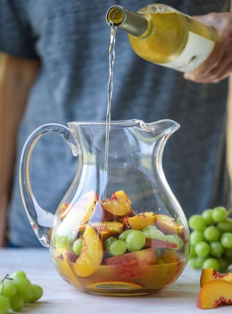 This pinot grigio sangria is absolutely perfect for summer, complete with peach nectar, fresh and frozen peach slices, brandy and bubbles! Frozen green grapes add some chill without watering down the drink. It's perfect! I howsweeteats.com #pinot #grigio #peach #sangria #cocktails #punch #summer #wine Pino Grigio Sangria, Frozen Green Grapes, Pinot Grigio Sangria, Peach Sangria Recipes, Happy Afternoon, Sangria Wine, Vodka Lime, Peach Nectar, Peach Sangria