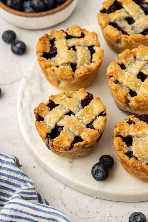 Easy Mini Blueberry Pies Recipe (Made In Muffin Tin!) Blueberry Pie Muffins, Blueberry Tart Recipe Easy, Small Blueberry Pie, Mini Pie Tarts, Cupcake Pan Pies, Blueberry Tarts Filling, Mini Blueberry Pies In Muffin Tin, Small Muffin Tin Recipes, Muffin Tin Pies