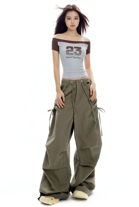 Capture the essence of casual chic with our Cargo Jogger Pants, perfect for the urban explorer. These jogger pants combine form and function with their strong cotton blend, sleek side pocket design, and comfortable drawstrings for an adjustable fit. The unique pleating at the knee not only enhances movement but adds a structured, edgy look to the silhouette. Effortlessly versatile, these joggers can be styled up with heels for a night out or paired with sneakers for a relaxed day in the city. Th Non-stretch Cargo Style Bottoms For Streetwear, Wide-leg Cargo Pants With Elastic Waistband For Streetwear, Outfit With Cargo Pants, Wide-leg Drawstring Cargo Pants For Streetwear, Streetwear Wide-leg Cargo Pants With Drawstring, Urban High-waisted Parachute Pants With Side Pockets, Jogger Outfit, Dance Outfits Practice, Joggers Outfit