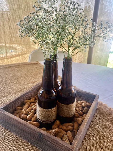 A Baby is Brewing 👶🏻🍺 Baby Shower decor Couples Baby Shower Gifts, Grandpa Birthday Decoration Ideas, Rustic Retirement Party Ideas For Men, Bro Shower Ideas, Couples Shower Centerpieces, Bottles And Brews Party, Western Centerpiece Ideas For Men, Beer Bottle Centerpieces For Men, Brewery Party Decor