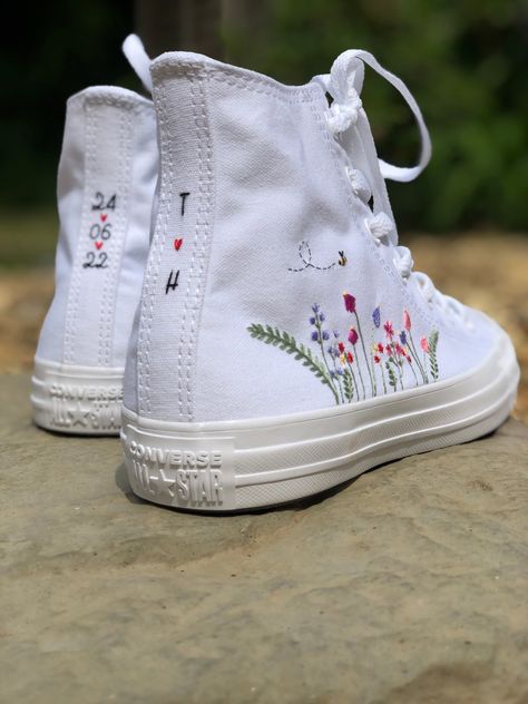 I hand embroidered these white monotone Converse trainers with a dainty flower and bee design. If these are for a special occasion then you can chose to have the back strips embroidered with a special date, initials, or something of your choice! I only purchase 100% genuine shoes from the official converse website. I then use high quality embroidery thread to embroider the outsides of the Converse with my dainty floral design. Sizes are in standard woman UK sizes **Because each pair of trainers Flower Embroidered Converse, Floral Embroidered Converse, Embroidery Wedding Shoes, Embroidered Converse Wedding, Embroidering Shoes, Embroidered White Converse, Bridal Trainers, Converse Flowers, Wedding Trainers