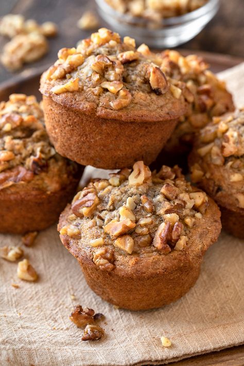 These bakery-style banana nut muffins are brimming with lots of sweet, ripe bananas, crunchy walnuts, brown sugar, and a kiss of spice! | thecozyapron.com #banananutmuffins #banananutmuffinsrecipe #banananutmuffinseasy #banananutmuffinsrecipemoist #banananutmuffinshealthy Banana Nut Muffins Healthy, Banana Walnut Muffins, Walnut Muffins, Nut Muffins, Banana Muffin, Banana Nut Muffins, Banana Muffin Recipe, Lemon Poppyseed Muffins, Banana Walnut