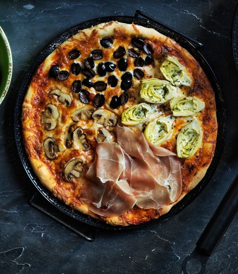 Pizza Quattro Stagioni | Literally “four seasons pizza,” a pizza quattro stagioni features four different toppings: mushrooms, olives, artichokes and prosciutto.