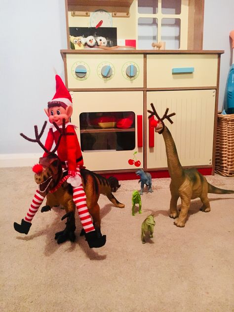 Elf on the Shelf. T-Rex and Dippy got antlers and red noses. We put chocolate coins in a sleigh pulled by a smaller dino too. Dino Elf On The Shelf, Dinosaur Elf On The Shelf, Elf On The Shelf Ideas Dinosaurs, Elf On Shelf Dinosaur, Elf And Dinosaurs, Elf Dinosaur Ideas, Dinosaur Elf On The Shelf Ideas, Elf On The Shelf Dinosaur Ideas, Elf Dinosaur