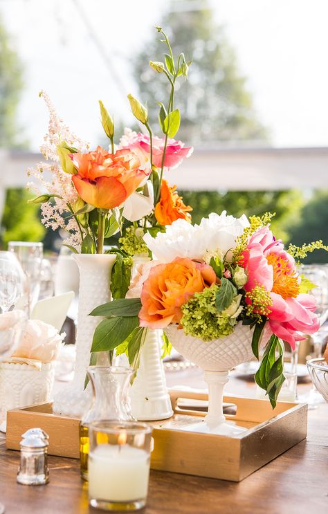 Mismatched Vintage Milk Glass Vase Centerpieces |  Mismatched Vintage Milk Glass Vase Centerpieces  FAVORITE      Fb2c404e 124c 11e4 843f 22000aa61a3e~rs 729 Centerpieces consisted of collected mismatched milk glass vases scattered on a lace runner with coral peonies, peach garden roses, ranunculus, craspedia and sprigs of other flowers.  FROM A WHIMSICAL, CHIC BARN WEDDING AT THE WINVIAN IN LITCHFIELD, CONNECTICUT Wedding Centerpieces Vases, Centerpieces Vases, Milk Glass Centerpiece, Milk Glass Wedding, Milk Glass Decor, Wedding Vase Centerpieces, Glass Vases Centerpieces, Vintage Centerpieces, Gold Color Palettes