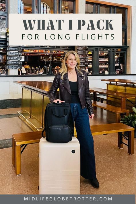 A woman stands with a beige roller bag and black backpack. She is wearing a brown moto jacket and jeans. Best Long Haul Flight Outfit, Best Outfit For Long Flight, Travel Essentials Flight, What To Take On A Long Flight, Long Flight Outfit Summer, Carry On Essentials Long Flights, Long Haul Flight Outfit Comfy, Carry On Aesthetic, Carry On Bag Essentials Long Flights