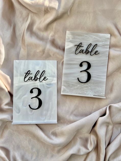 Laser cut acrylic table numbers available in a unique pearl and marble effect acrylic. These are perfect as wedding table decorations or for other event signage.  A6 - 105mm x 148mm  A5 - 148mm X 210mm  All have an additional 3mm tab to locate into 3mm acrylic base (as seen in pictures).  If you have any questions, please feel free to get in touch. Pearl Table Numbers, Luxe Romance, Wedding Table Number Signs, Acrylic Table Numbers, Taylor Wedding, Table Decor Wedding, Acrylic Table Number, Wedding Moodboard, Romance Wedding