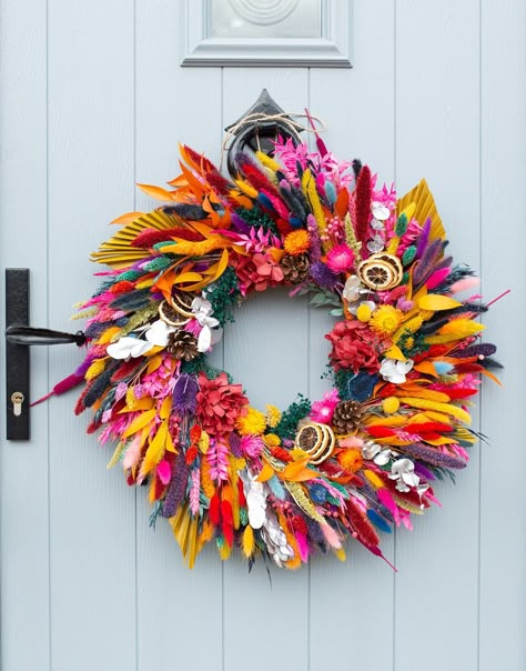 A large handmade dried flower wreath in a mixture of bright, rainbow colours. Perfect for a uniquely colourful Christmas! Measures approximately 55 - 60cm in diameter. The wreath comes supplied with a length of natural twine attached with which to hang. We recommend that dried flower wreaths are displayed indoors only to ensure their longevity. Unique Door Wreaths, Colourful Christmas Wreath, Amazing Christmas Decorations, Unique Christmas Wreaths, Colorful Christmas Wreath, Flower Christmas Wreath, Dried Flower Christmas, Holiday Front Door Decor, Colorful Wreaths