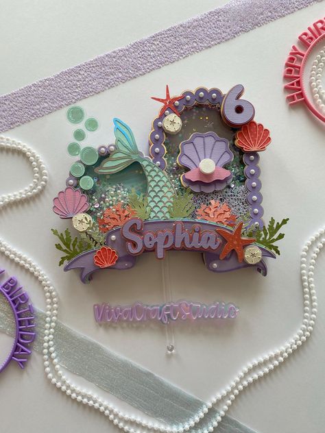 A truly special cake topper for your mermaid and under the sea themed birthday parties!  Cake topper dimensions are approximately 9.25 inches wide by 8 inches tall.  Cake topper stick is removable! Our cake toppers make wonderful keepsakes after your party. They can be kept on a shelf or in a shadow box frame.  We are happy to accommodate any special requests, for example changing colors to suit your vision for your party. Please send us a message if you have any customizations in mind.  Other items we carry that match this theme: Mermaid 3D letters and/or numbers: https://vivacraftstudio1.etsy.com/listing/1772418768  Mermaid party banner: https://vivacraftstudio1.etsy.com/listing/1786606685  If you have a different idea or inspiration in mind for your party, and would like a bespoke desig Mermaid 3d, Tall Cake, Tail Mermaid, Mermaid Cake Topper, Under The Sea Birthday Party, Sea Birthday Party, Under The Sea Birthday, Mermaid Cakes, Sea Birthday