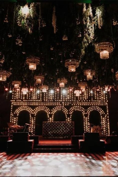 Beautiful & Unqiue Stage Decor Ideas for your wedding funtions. #weddingbazaar #indianwedding #stagedecorringceremony #stagedecorwedding #stagedecorreception #stagedecorengagement #stagedecorsimple #stagedecorideas #stagedecorgrandwedding #stagedecorsimplewedding #stagedecorhaldi #stagedecorsangeet #stagedecor Cocktail Party Stage Decor, Reception Decor Ideas Indian, Sufi Stage Decor, Sangeet Night Stage Decor, Sangeet Stage Design, Sangeet Ideas Themed Parties, Cocktail Stage Decor, Cocktail Party Decorations Night Indoor, Sangeet Dance Stage