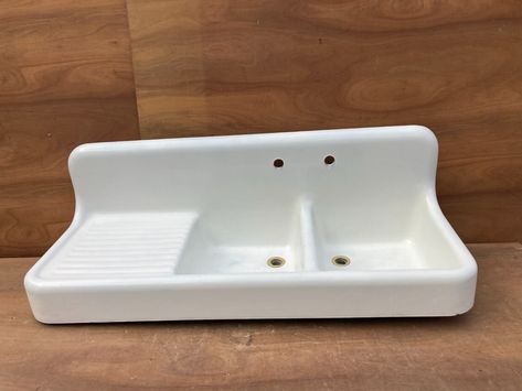 THIS SINK IS PICK UP ONLY OR WE WILL BUILD A PADDED CRATE FOR AN ADDITIONAL $225. BUT BUYER IS RESPONSIBLE FOR SCHEDULING AND PAYING FOR SHIPMENT/DELIVERY.  DO NOT GO BY THE AMOUNT ENTERED FOR SHIPPING, AS WE HAD TO  PUT AN AMOUNT SO PEOPLE DIDN'T GO TO CHECK OUT. Great antique cast iron white porcelain double basin kitchen sink. Very hard to find sink with the double basin single drainboard. It is marked Standard Sanitary mfg. c.1920s. The porcelain shows normal wear, there are scratches & scuffs, some pockmarks, some pitting in the basins, and a few small chips. The original wall brackets are included as shown. Overall good, salvaged condition. Please be sure to look over all of the pictures as they are the best description. Feel free to ask questions when needed. Thanks for looking!  Me Antique Farmhouse Sink, Porcelain Kitchen Sink, Mudroom Laundry Room Ideas, Kohler Kitchen Sink, Vintage Farmhouse Sink, Double Basin Kitchen Sink, Porcelain Kitchen, Cast Iron Sink, Double Kitchen Sink