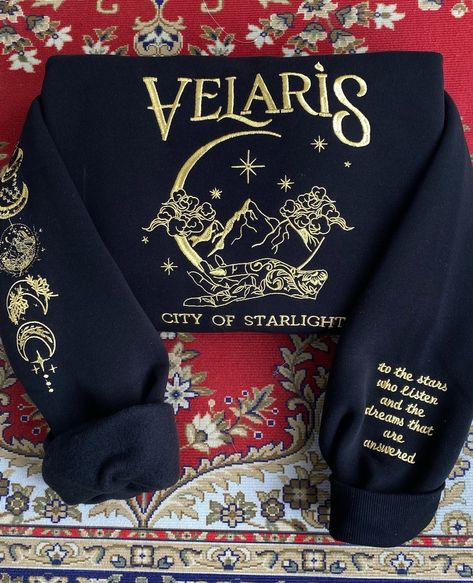 🌠 ✨ Embroidered sweatshirt for ACOTAR fans! 🥰 #bookish #BookMerch #bookseries #BookTok #bookishmerch #bookworm #acotar #acotarseries #acotartok #velaris #velarisacotar #velariscityofstarlight #thebatboys #bookstagram Acotar Accessories, Acotar Gift Ideas, Acotar Gifts, Acotar Sweatshirt, Booktok Merch, Acotar Merch, Book Basket, Iron Flame, Book Merch