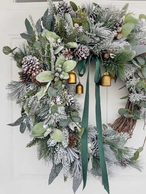 This beautiful snow-covered (flocked) greenery wreath is just right for celebrating the season. Even if you live in a warmer climate, who doesn't love the idea of a white Christmas? Fern, evergreens, soft lamb's ear, eucalyptus and pine cones are dusted with a snowy coating and treated with a preservative and UV blocker to ensure the beauty of your wreath lasts for years. You may purchase this wreath with or without bells according to your preference. Take care to avoid prolonged direct sunlight Christmas Lambs Ear Wreath, Wreath With Bells Christmas, Christmas Wreaths Boho, Sage Green Christmas Wreath, Flocked Christmas Wreath Ideas, Christmas Wreaths Rustic, Winter Door Wreaths, Winter Wreaths For Front Door, Eucalyptus And Pine