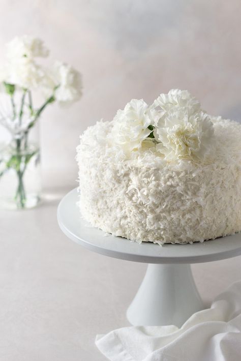 I have something special for my coconut lovers out there: Coconut Layer Cake with Swiss Meringue Buttercream. It's rich, decadent and perfectly coconuty. #easterrecipes #dessertrecipes #cake #coconut Coconut White Chocolate Cake, Coconut Cake Wedding, Coconut Cake Decoration Ideas, Single Layer Coconut Cake, Coconut Swiss Meringue Buttercream, Coconut Cake Photography, Birthday Cake Coconut, Coconut Wedding Cake, Coconut Lime Layer Cake