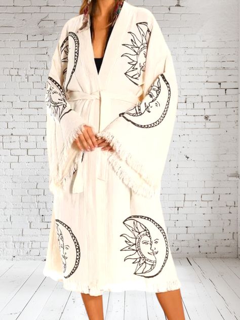 Wrap yourself in effortless bohemian elegance with the Luna y Sol Kimono, crafted from luxurious Turkish cotton. Featuring a celestial sun and moon motif in a bold, hand-drawn design, this lightweight, flowy piece is the perfect layering essential for any free-spirited wardrobe. The wide sleeves, fringed edges, and relaxed silhouette make it a versatile staple that exudes laid-back luxury. One size fits most, making it an easy, breezy addition to your closet. How to Style: Drape it over a bikini Celestial Sun And Moon, Tube Maxi Dresses, Celestial Sun, Easy Breezy, Kimono Dress, Hand Drawn Design, Free Spirited, Wide Sleeves, Sun And Moon