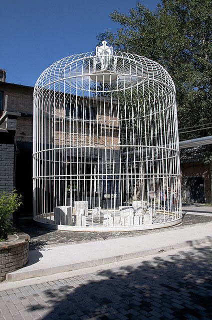 I like the cage however, and I would change the shape to make it look interesting. Bird Cage Decor, Roadside Attractions, Outdoor Pergola, Bird Cage, Awe Inspiring, Pretty Cool, Skyscraper, Multi Story Building, Pergola