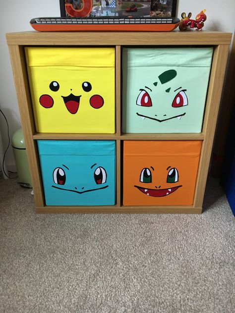 Ikea Kallax unit with Drona boxes and felt “first partner” Pokemon faces applied with heat n bond.. Pokemon Man Cave, Pokemon Furniture Diy, Pikachu Room Ideas, Pokemon Mural Bedroom, Pokemon Nursery Ideas, Pokemon Room Decor Ideas, Pokemon Theme Bedroom, Pokémon Theme Room, Pokemon Organization Ideas