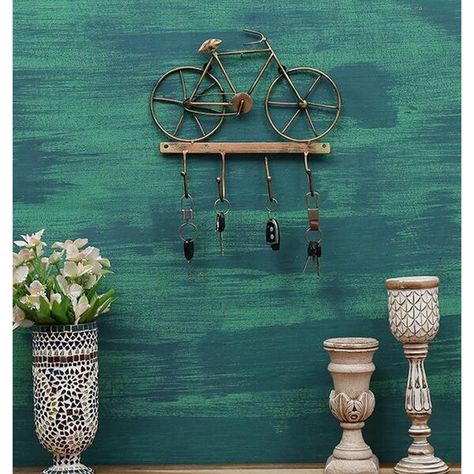 Pick something antique looking, highly decorative, and useful for home which is a cycle key holder available online for you. The product is a useful key holder for wall mount that can hang up to four keys at the same time. It is an attractive looking metal key holder available in a cycle shape along with a durable body that lasts for a longer duration of time. #CycleKeyHolder #HangingKeyHolderForWall #IronCycleWallHanging #KeyHangingForWall #MetalKeyHolder #MetalKeyHolderForWall Key Holders For Wall, Metal Key Holder, Wedding Packing, Home Decor Items Online, Housewarming Decorations, Dining Room Wall Decor, Great Wedding Gifts, Wall Key Holder, Indian Artist