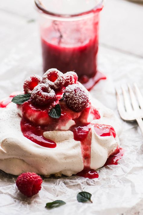 An individual raspberry pavlova dessert with jar of raspberry sauce. Raspberry Recipes Dessert, Raspberry Pavlova, Pavlova Dessert, Berry Dessert Recipes, Mini Pavlova, Meringue Desserts, Raspberry Desserts, Pavlova Recipe, Berry Dessert