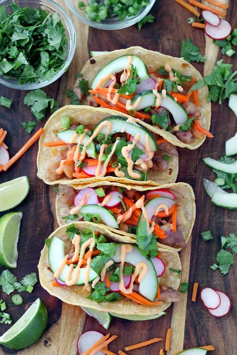 Chicken Banh Mi Tacos are bursting with fresh Vietnamese flavor. Marinated chicken thighs and pickled veggies, wrapped in toasted corn tortillas, topped with a spicy mayo and cool cucumber and herbs! This is an easy, gluten free recipe. via @bowlofdelicious Banh Mi Tacos, Chicken Banh Mi, Toasted Corn, Bahn Mi, Marinated Chicken Thighs, Gluten Free Recipe, Spicy Mayo, Pickled Veggies, Banh Mi